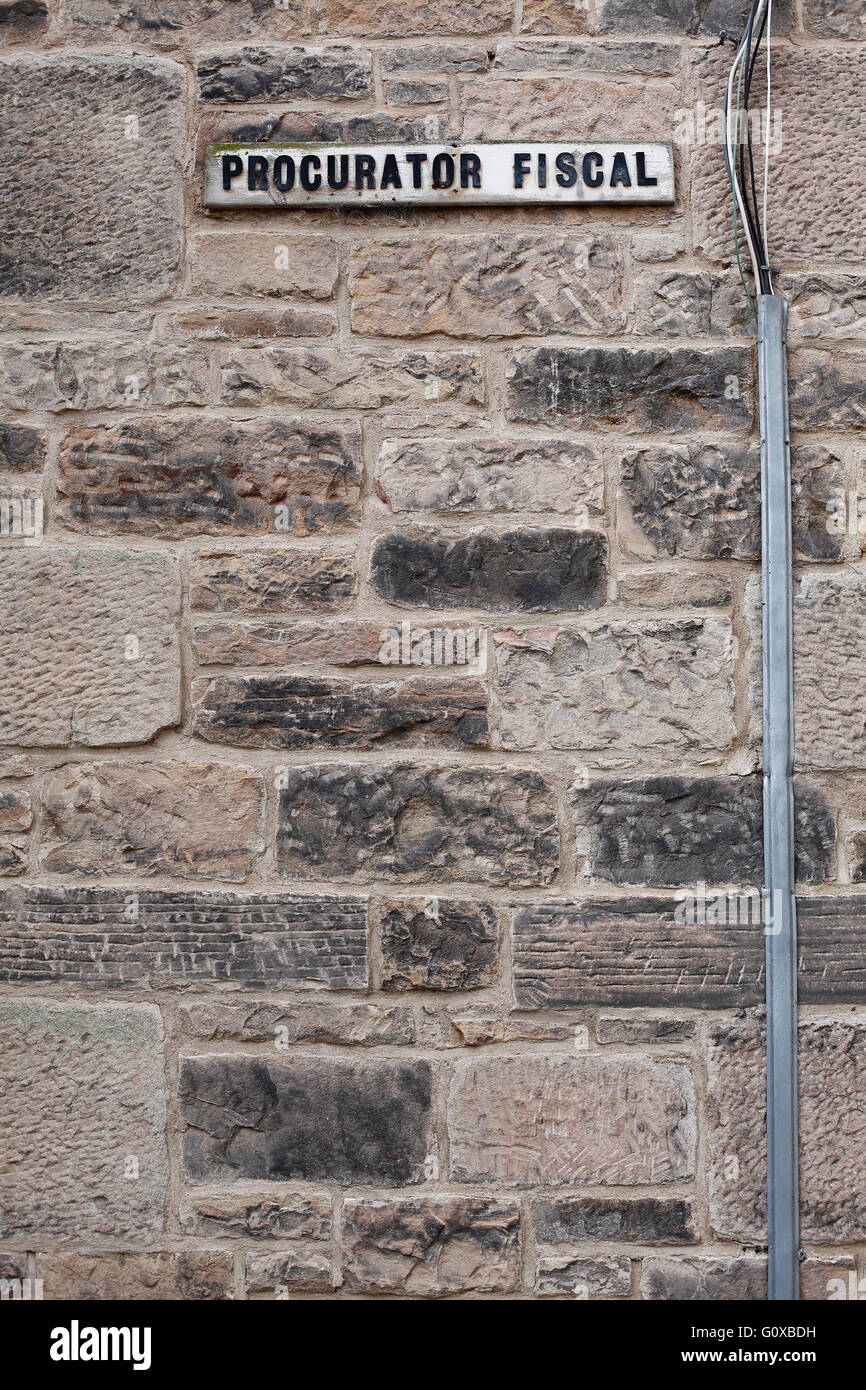 A sign on the wall of a car park in Jedburgh, Scotland, indicates where the Procurator Fiscal's car parking space is situated. Stock Photo