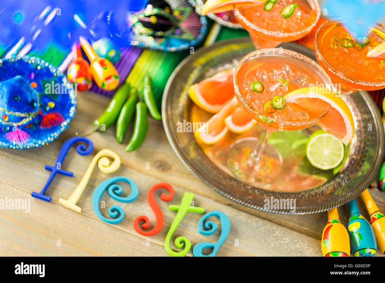 Spicy grapefruit margarita on ice in margarita glasses on the table in the garden. Stock Photo