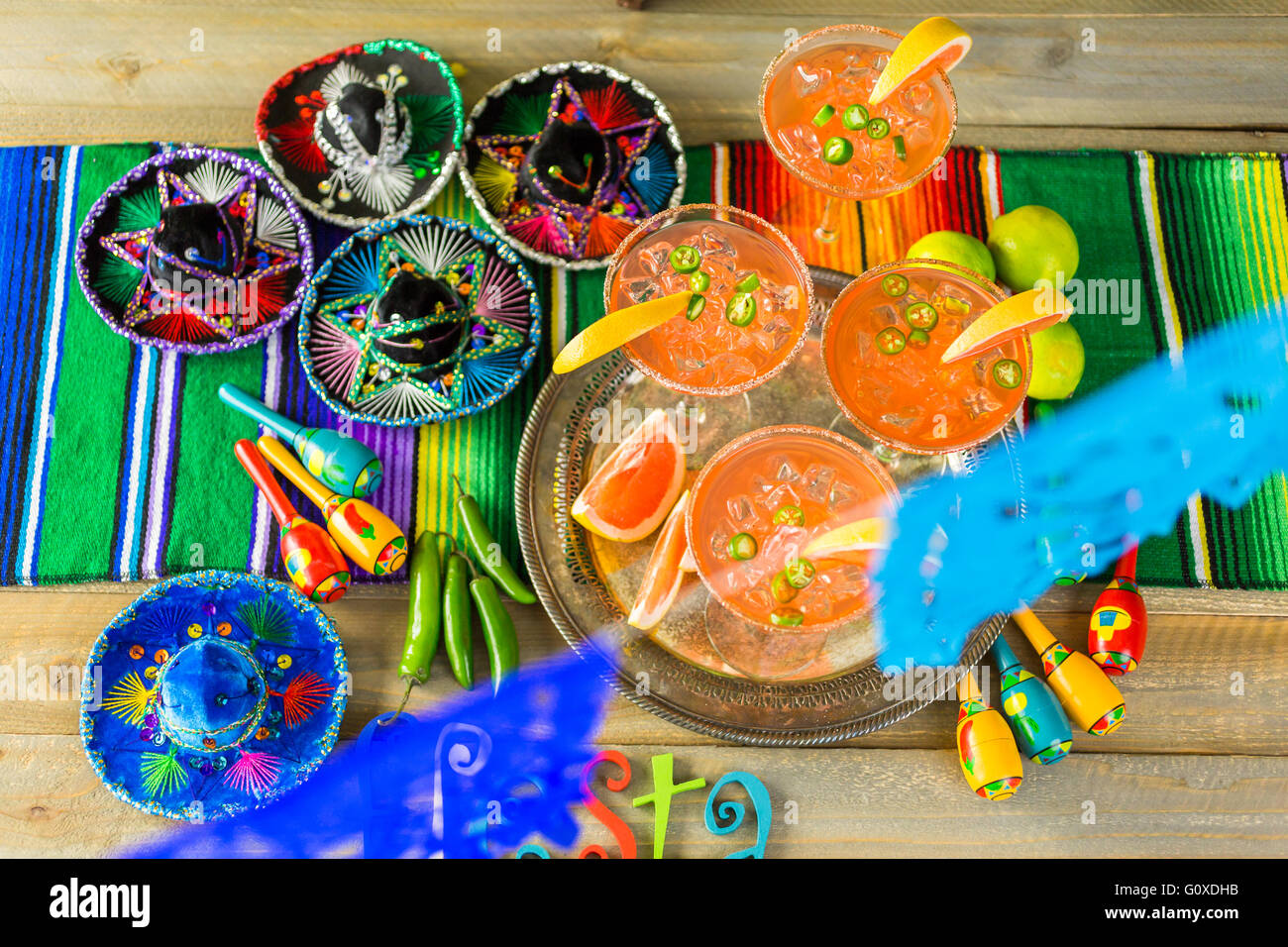 Spicy grapefruit margarita on ice in margarita glasses on the table in the garden. Stock Photo