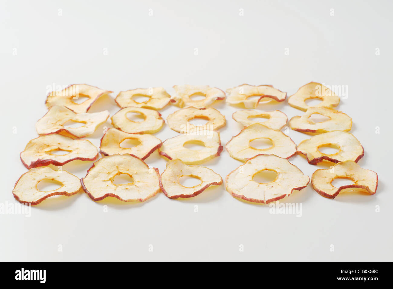 dried apple chips ranked on white background Stock Photo Alamy