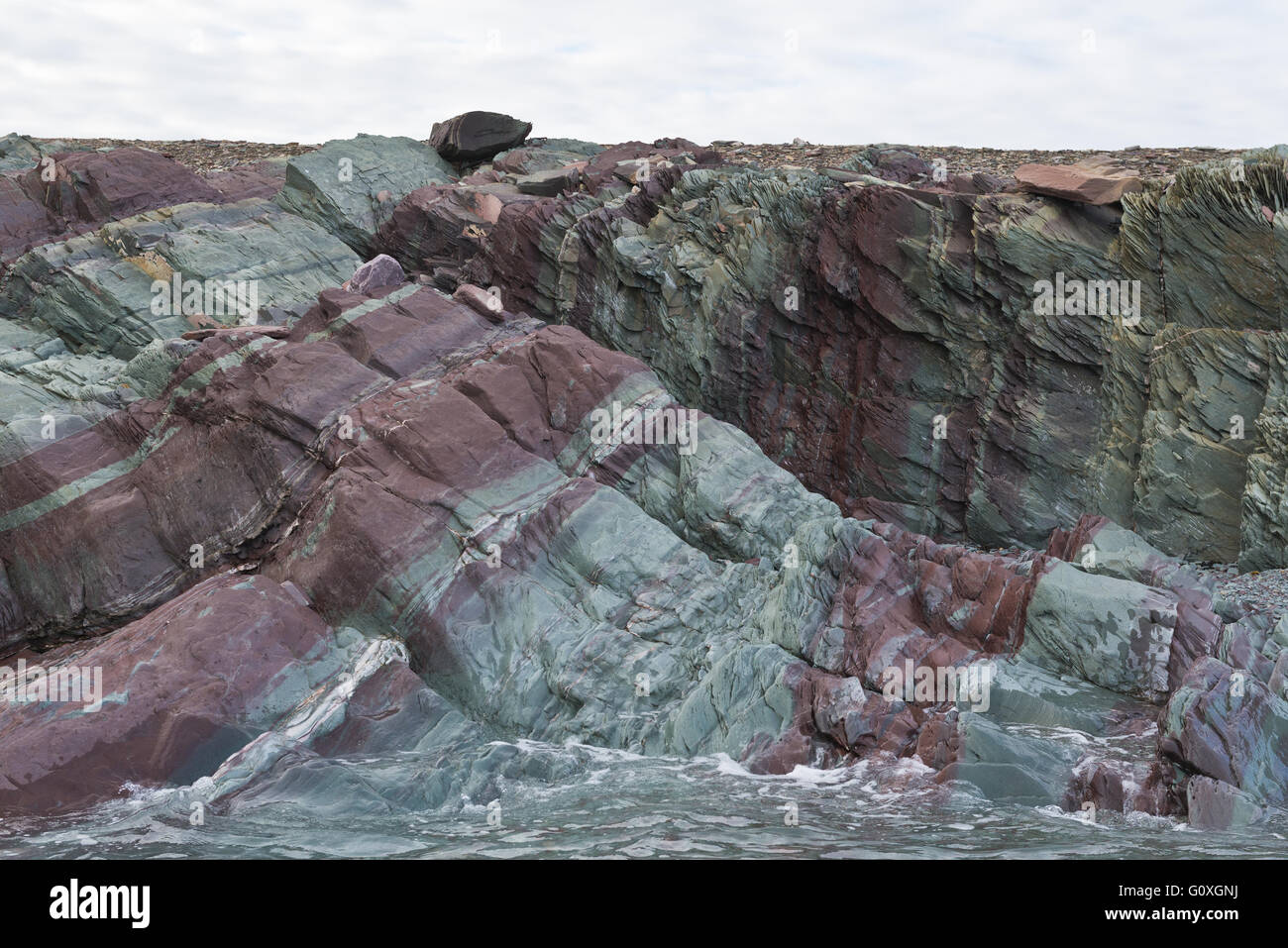 Colourful rocks in the sea cliffs at Murchinsonfjorden on ...