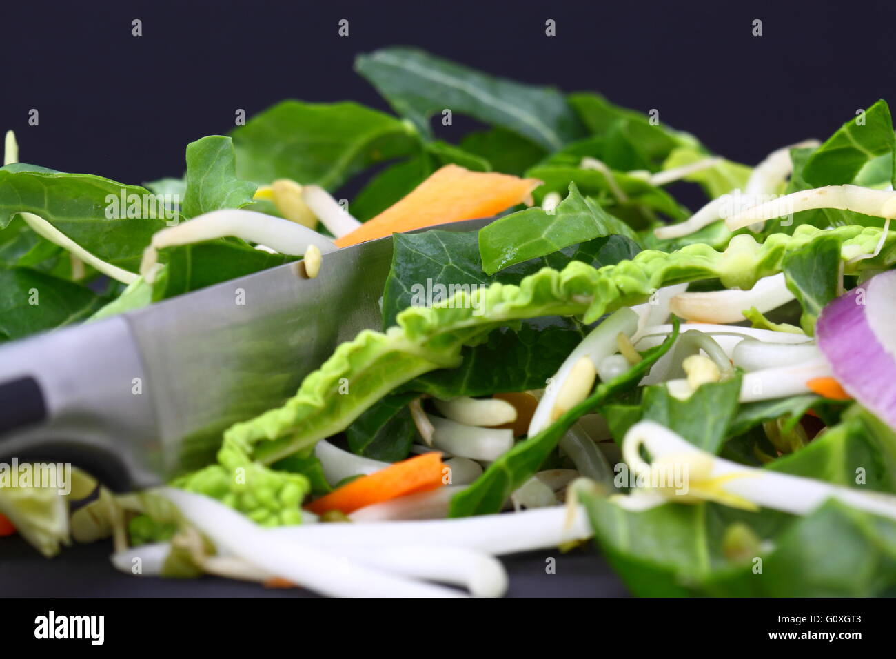 Cutting vegetables for a stir fry with a knife Stock Photo Alamy