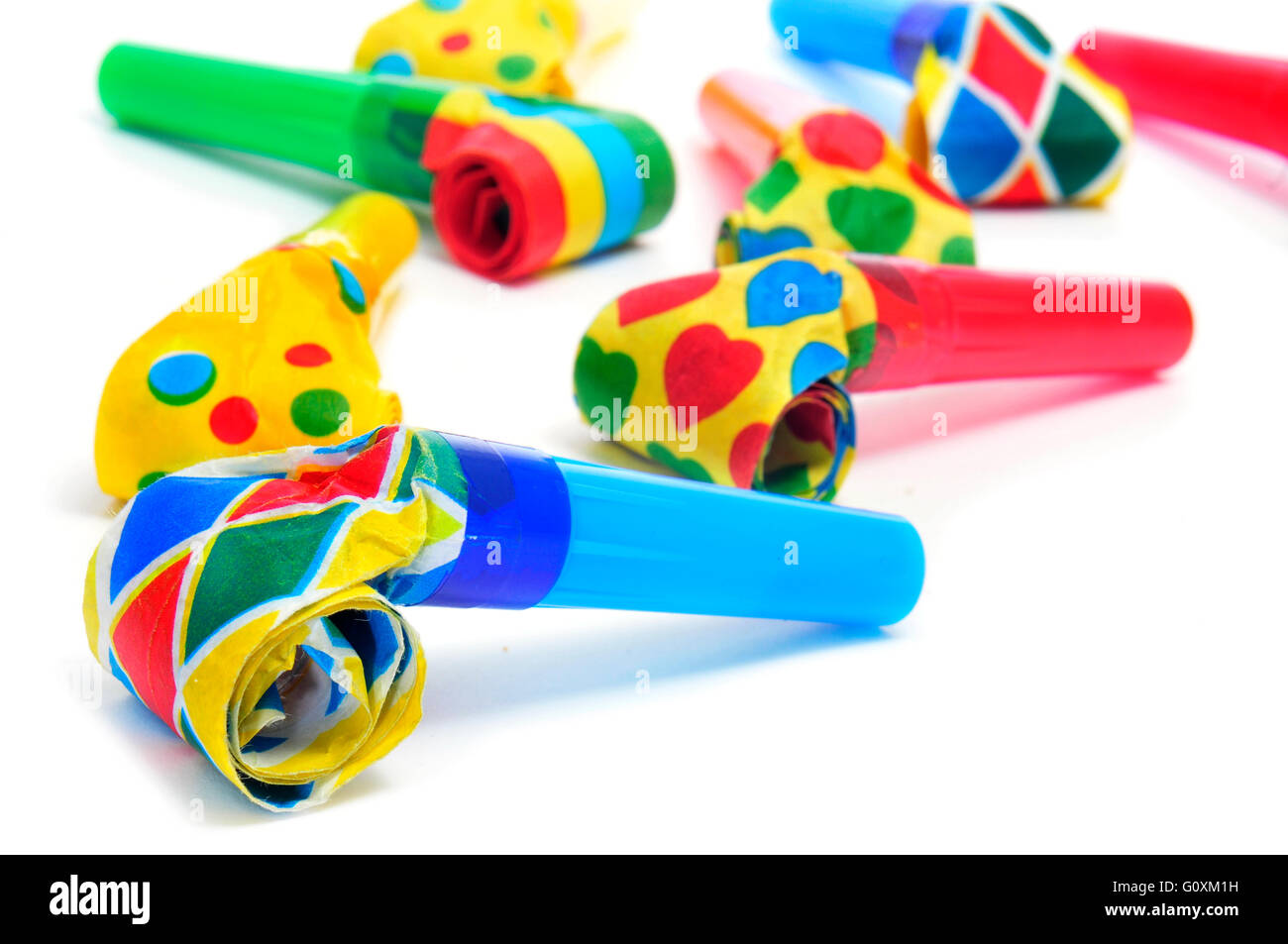 some party horns of different colors on a white background Stock Photo ...