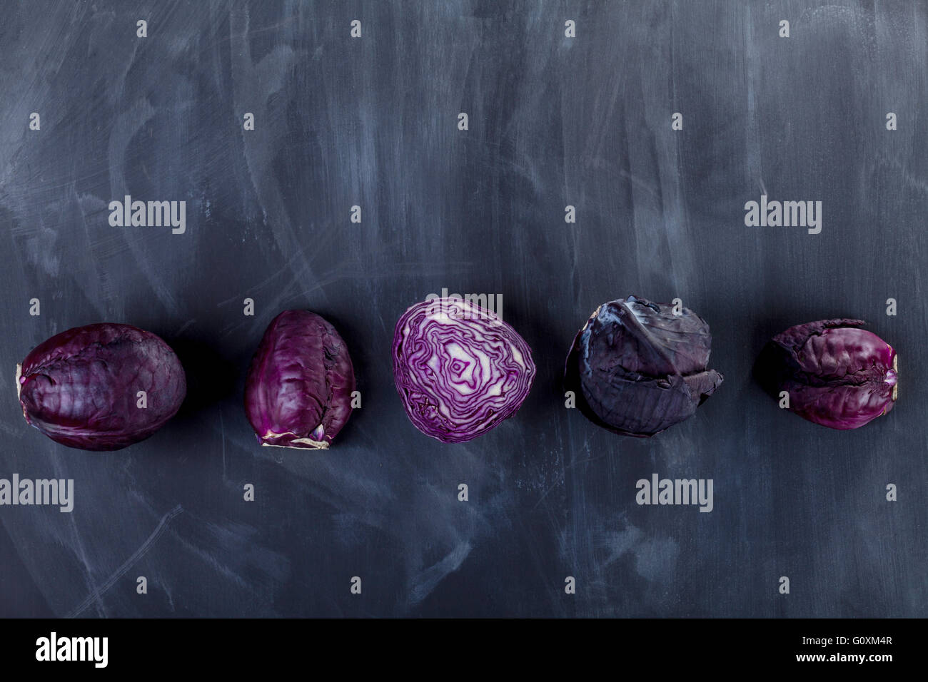 Five red cabbages on the blackboard from the top Stock Photo
