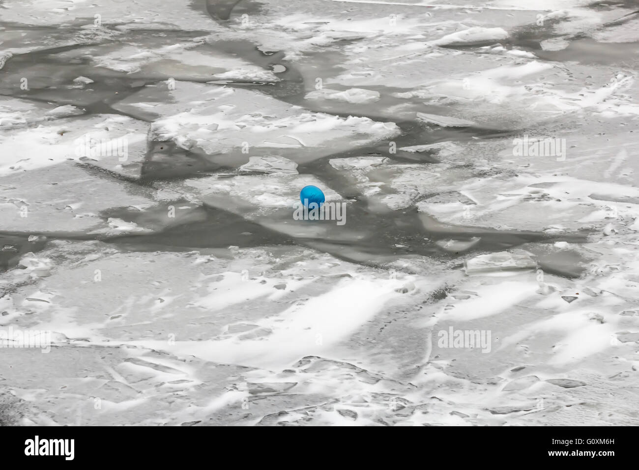 Blue balloon on grey ice at winter cloudy day Stock Photo - Alamy