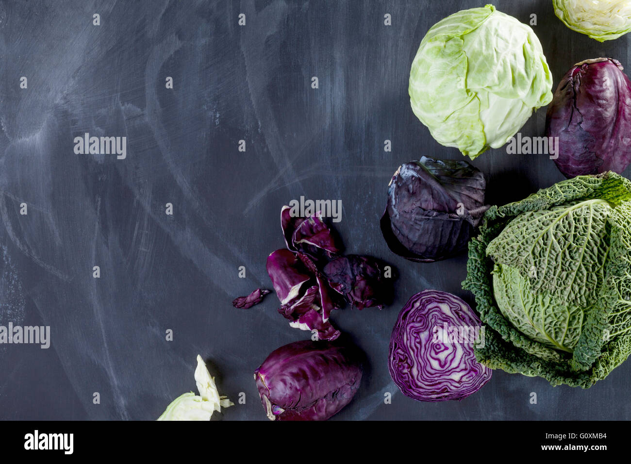 Different cabbages on blackboard from the top Stock Photo