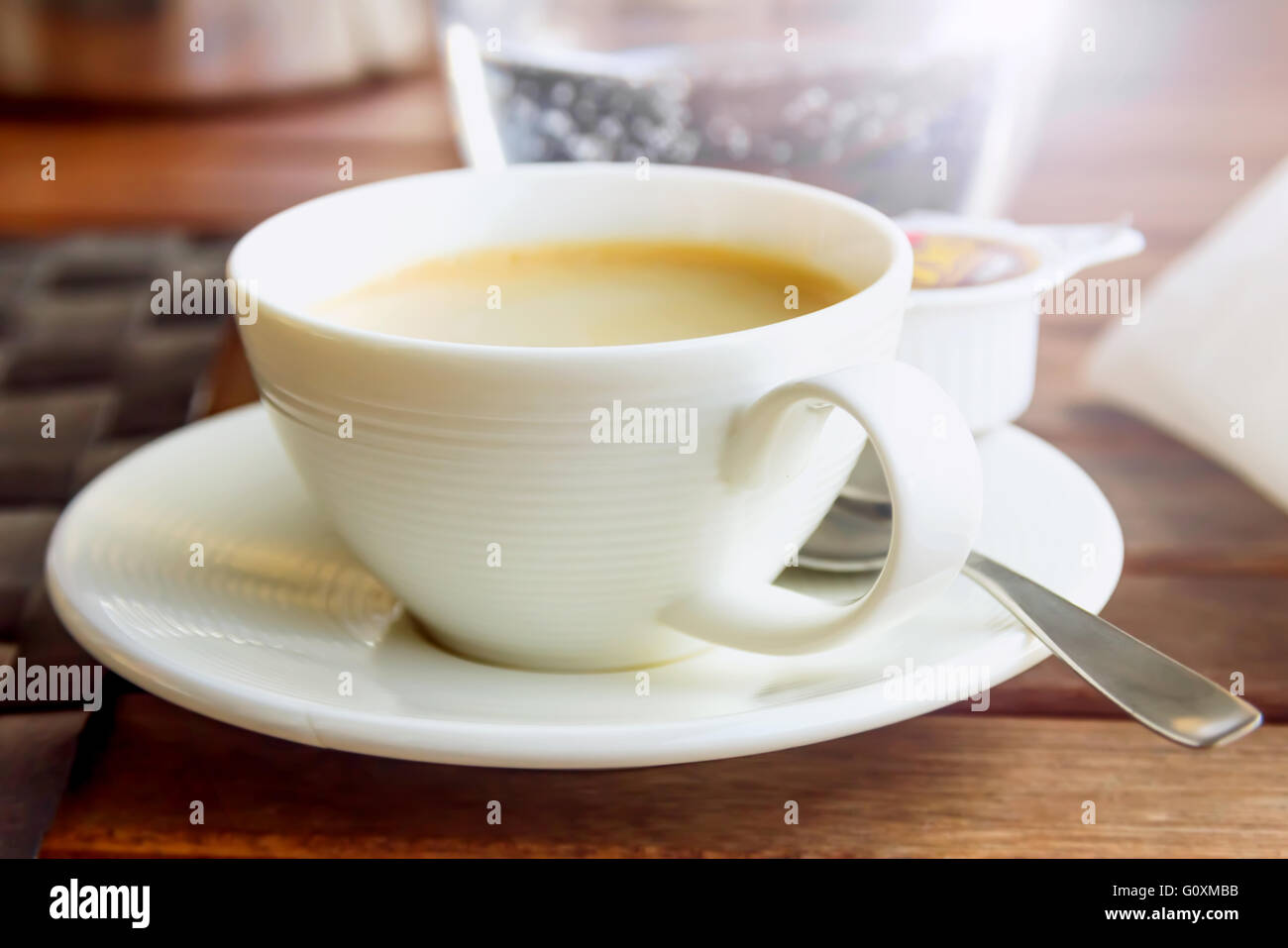 Fresh coffee with milk in white cup and saucer Stock Photo