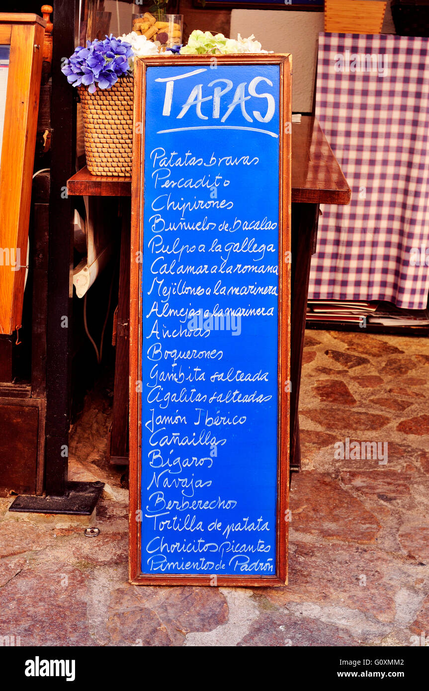 the chalkboard menu in a restaurant in Spain, with different spanish tapas, such as patatas bravas or tortilla de patatas Stock Photo