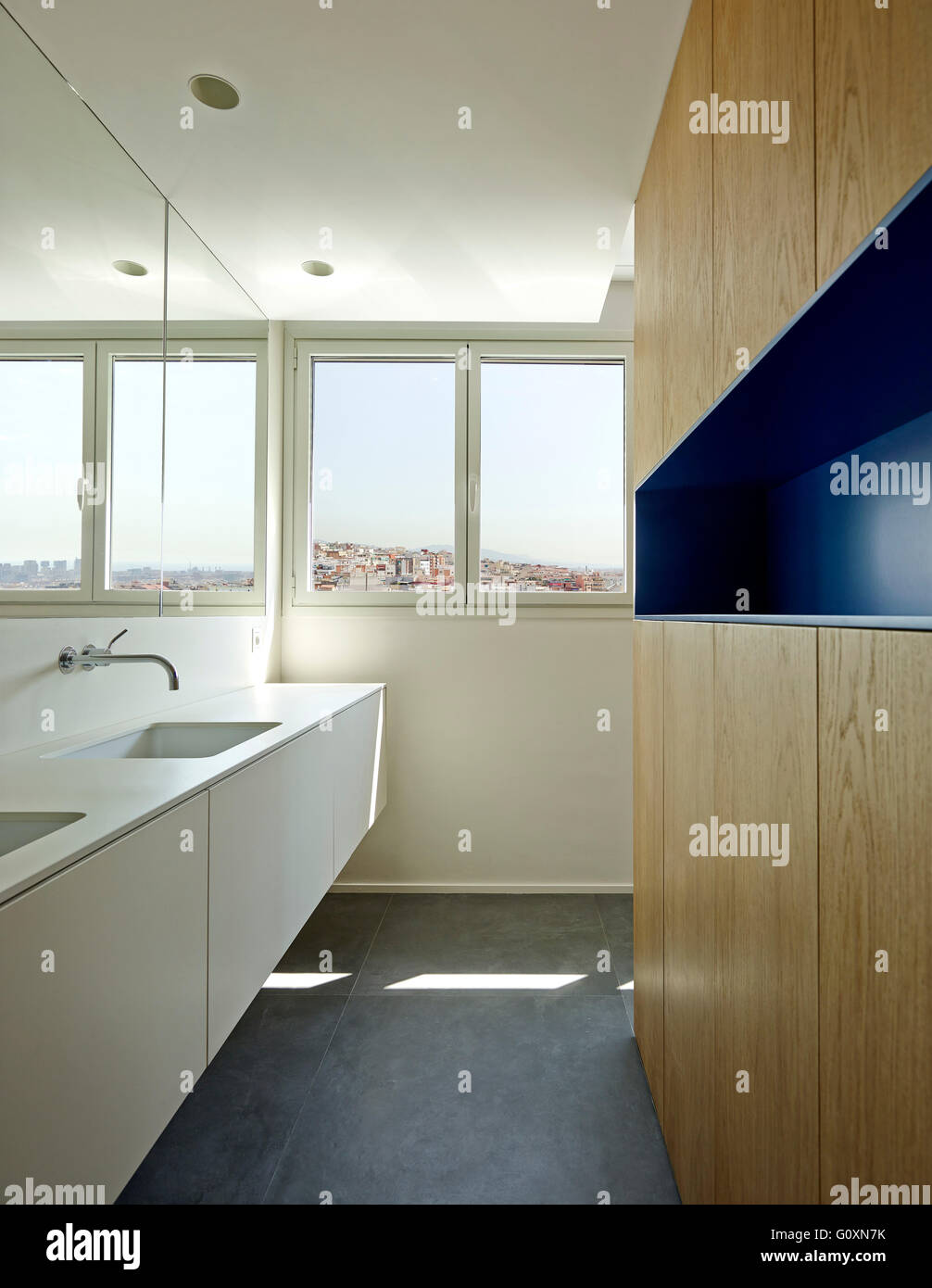 Escorial Apartment, Barcelona, Spain. Modern bathroom with white sinks