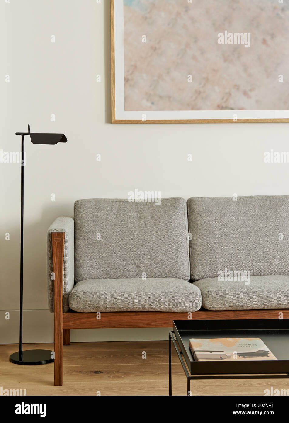 Partial View Of Modern Grey Couch With Painting Hanging Above In