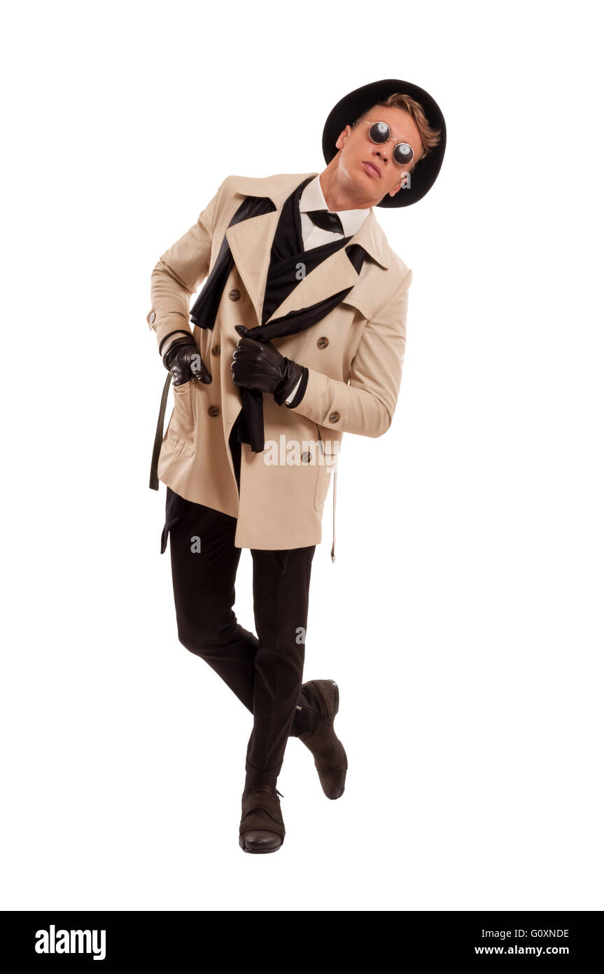 Male model wearing a detective coat posing in a photo studio with attitude, isolated on a white background Stock Photo
