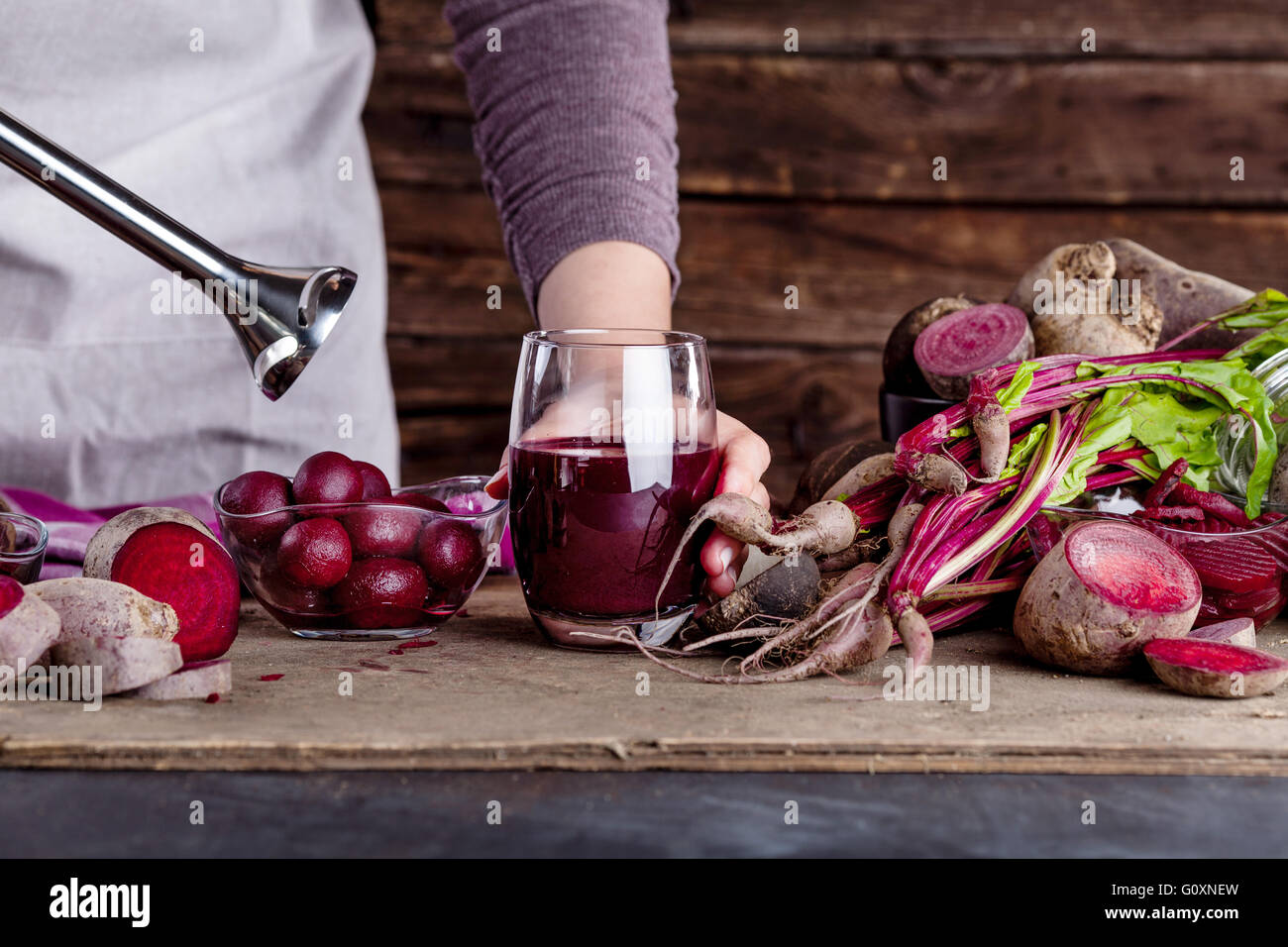 Cook is preparing a beetroot juice with blender Stock Photo