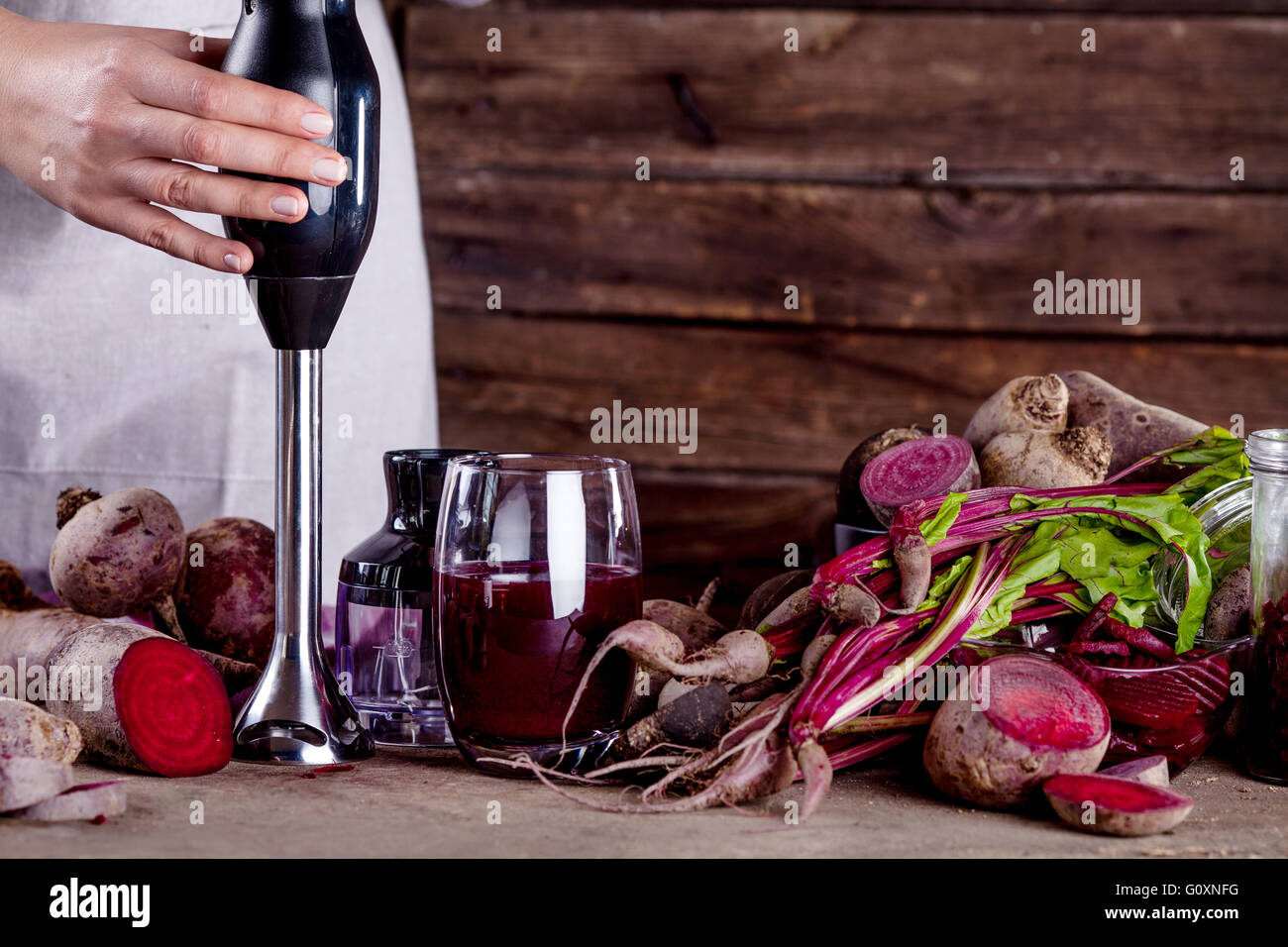 Cook is making a beetroot juice with blender Stock Photo