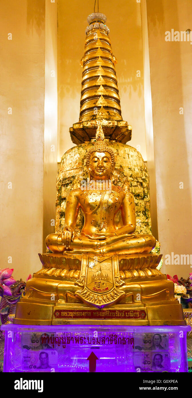 Buddhism, money, wealth. we see a violet plastic box with arrow and slot to insert money. Stock Photo