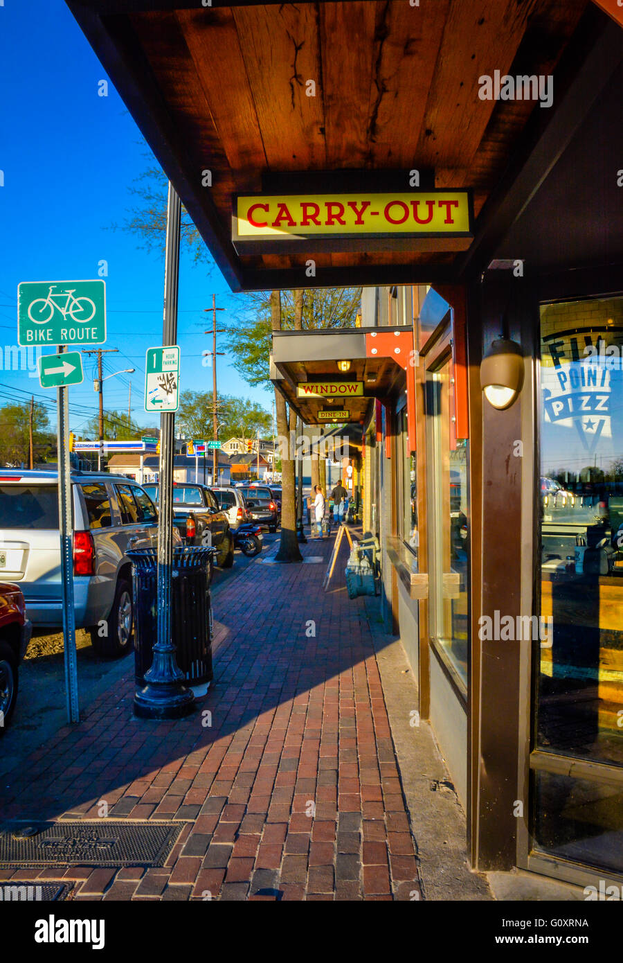 Storefront view down sidewalk at Five Points Pizza, the heart of the trendy 5 points area in East Nashville,TN Stock Photo