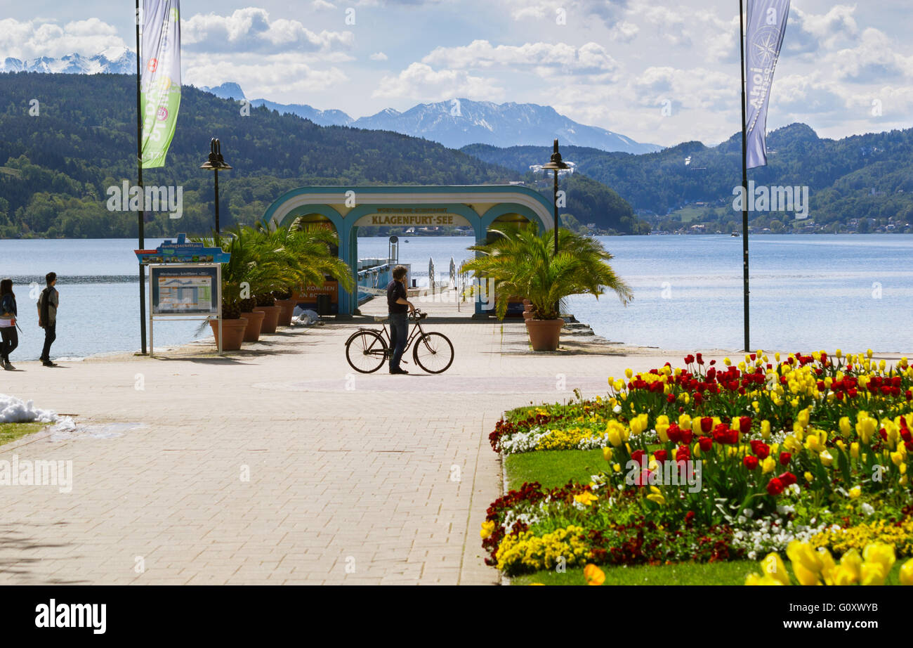 Lake view with cyclist mountains and flowers in Klagenfurt, Worthersee