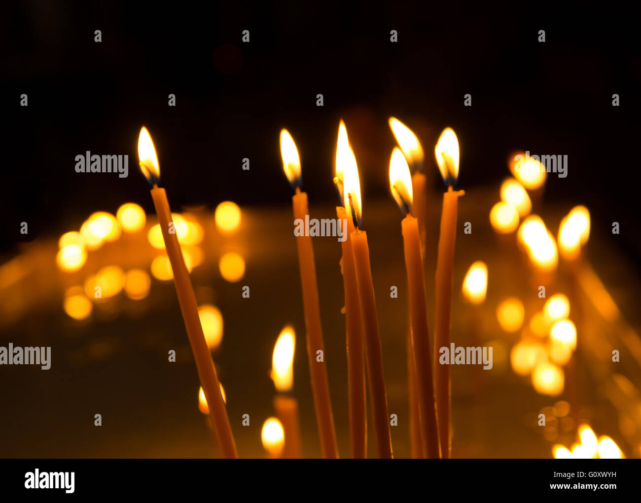 Burning candles on dark background Stock Photo - Alamy