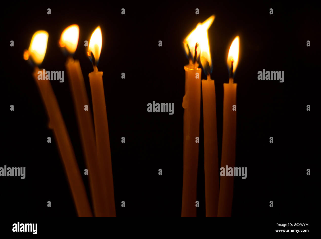 Burning candles on dark background Stock Photo - Alamy