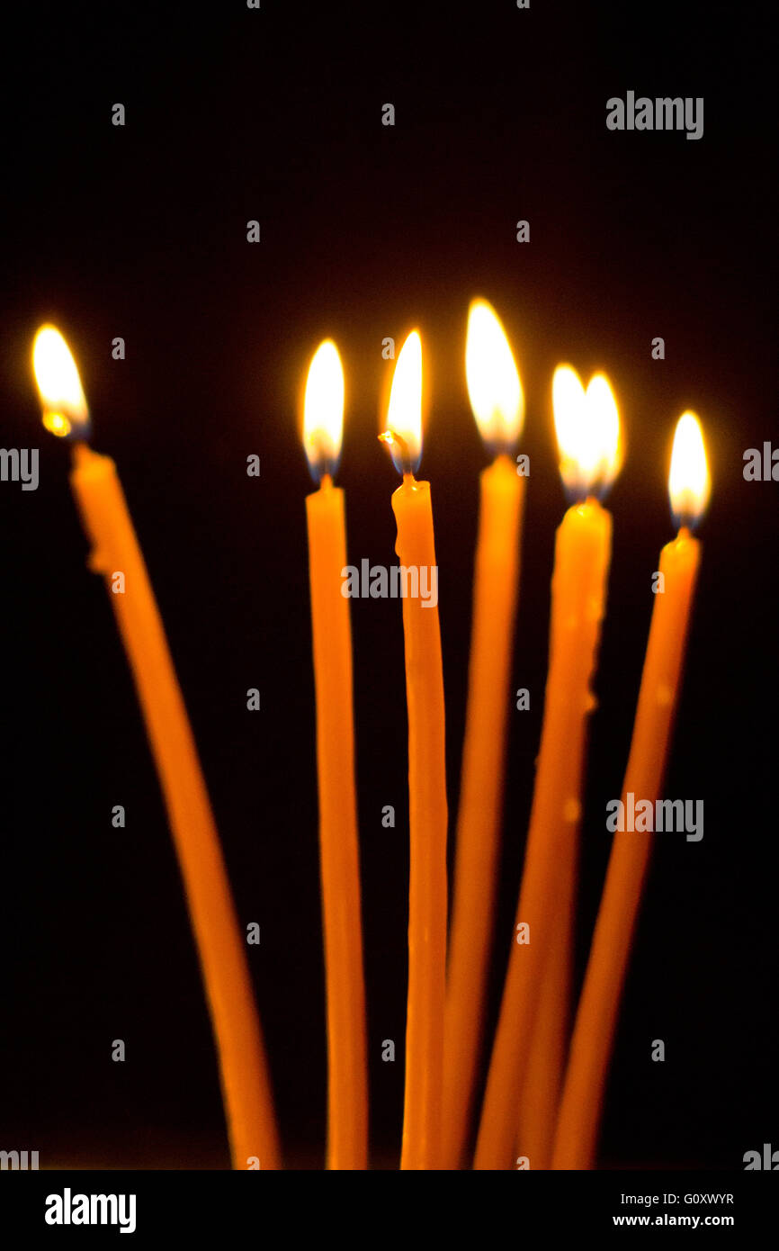 Burning candles on dark background Stock Photo - Alamy