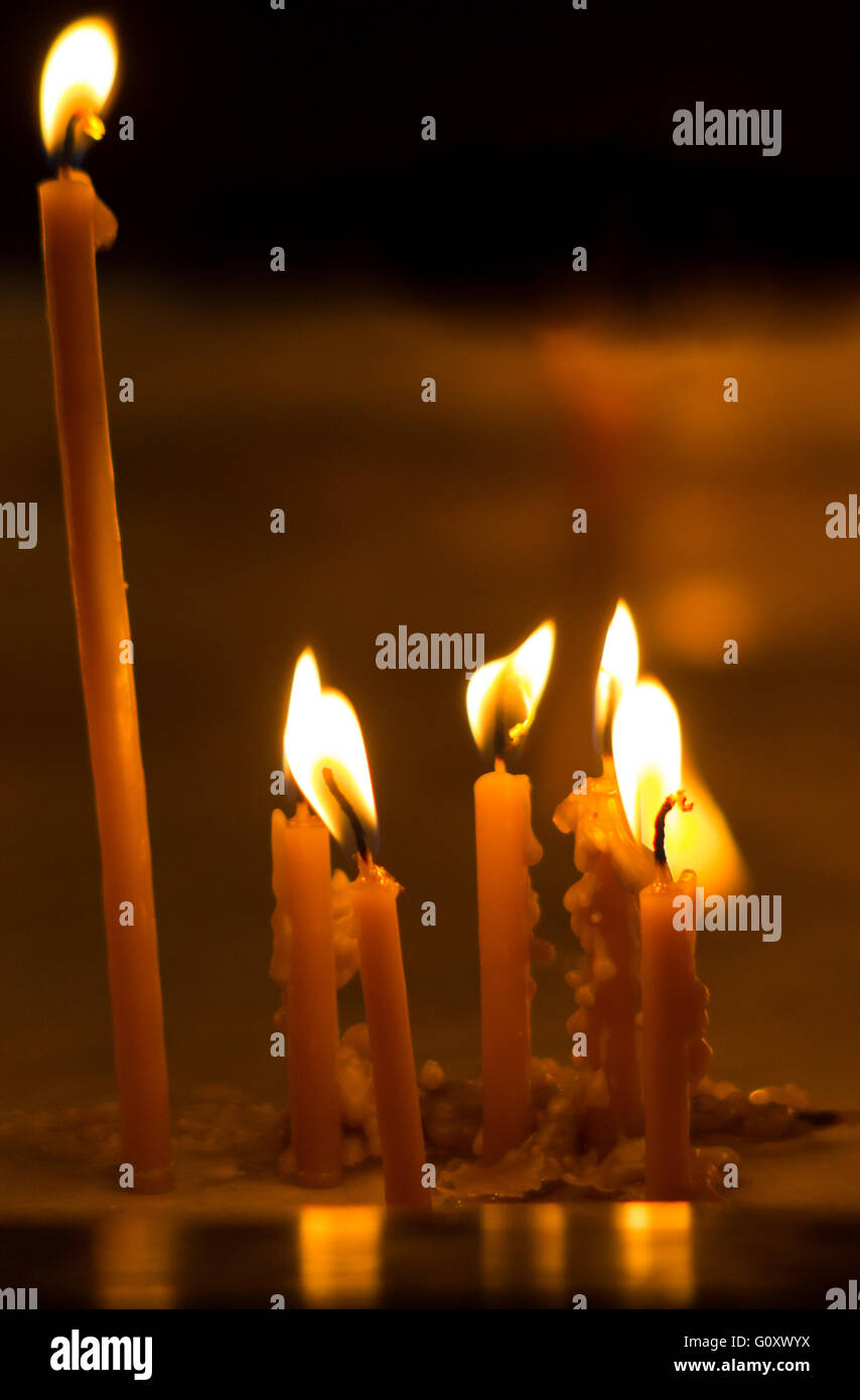 Burning candles on dark background Stock Photo - Alamy