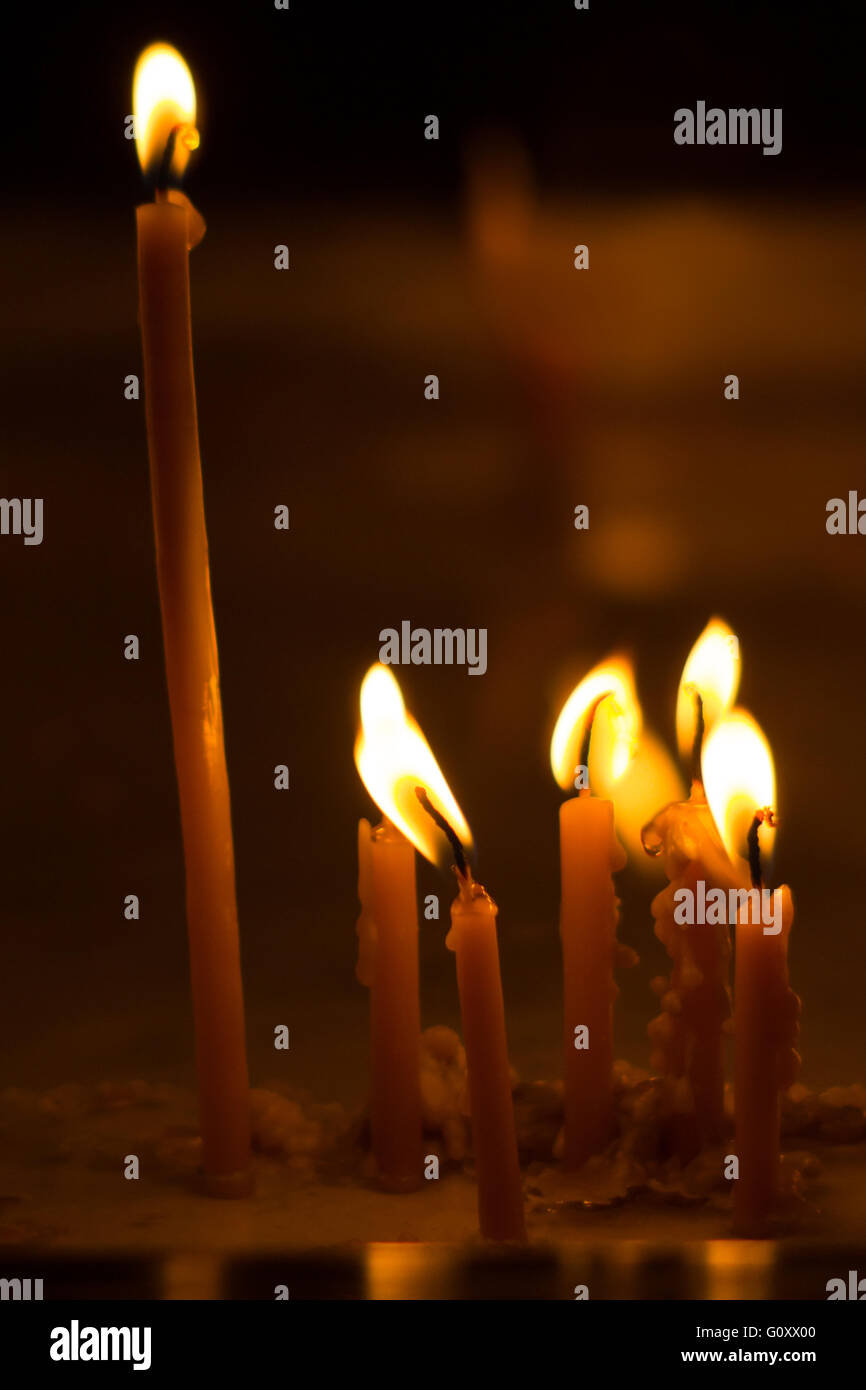 Burning candles on dark background Stock Photo - Alamy