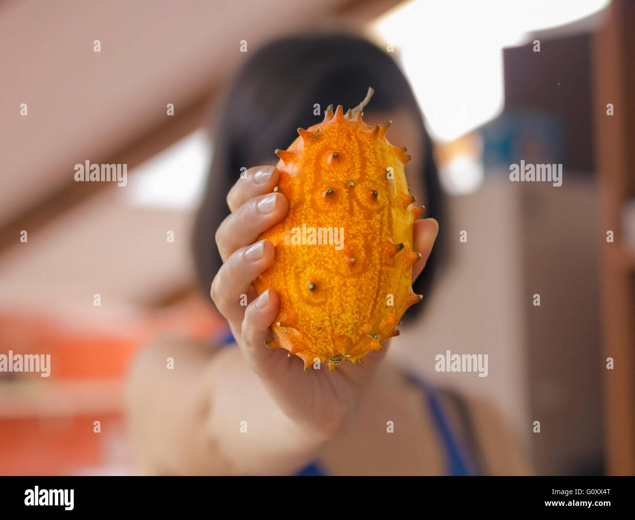 Woman holding an African Horned Melon Stock Photo