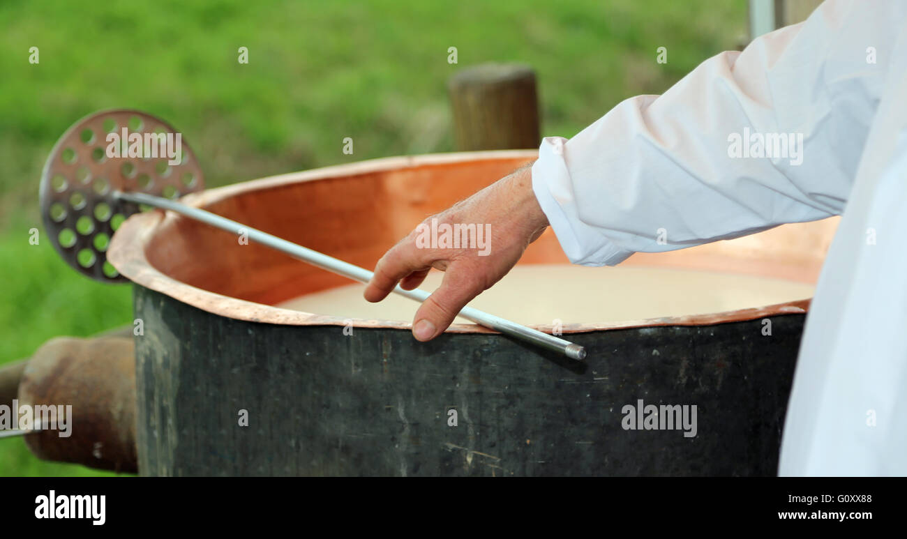 Cheesemaker Checks With Hand The Milk's Temperature Inside The Large ...