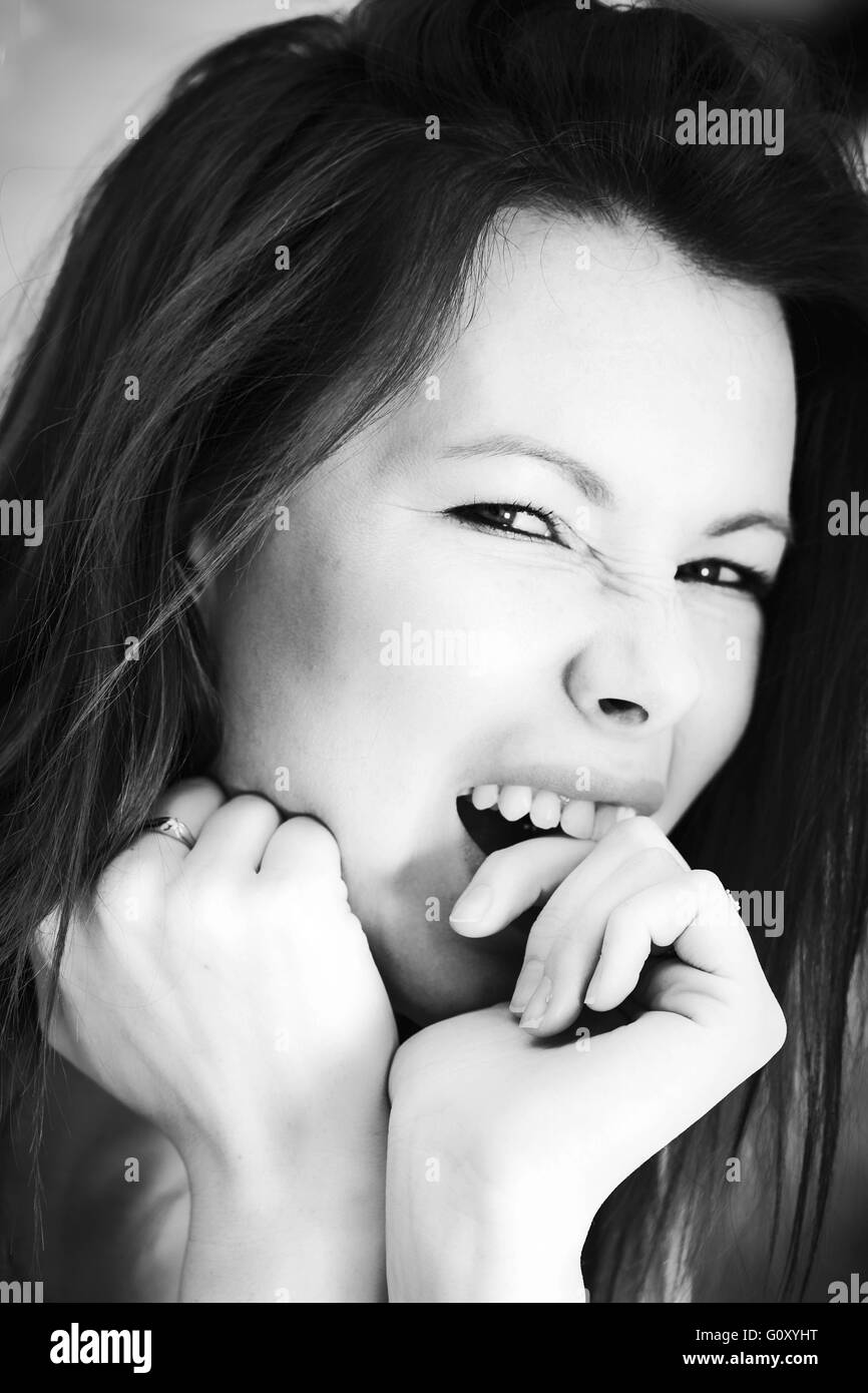 Portrait Of A Woman Outside Biting Her Finger Frustrated and Angry Stock Photo