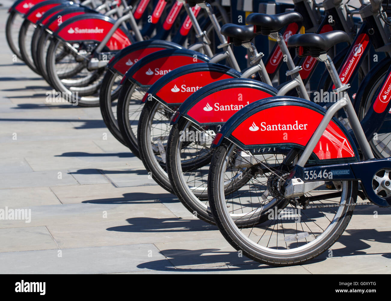Rows of Santander Bank sponsored bikes in London's bicycle hire scheme. Boris bikes on London's streets. Stock Photo