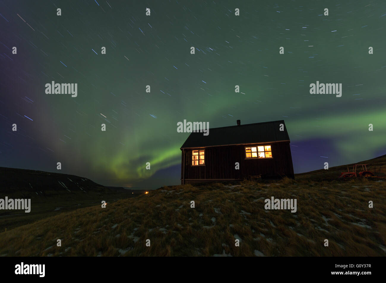 Northern Lights and stars over a cottage at night Stock Photo - Alamy