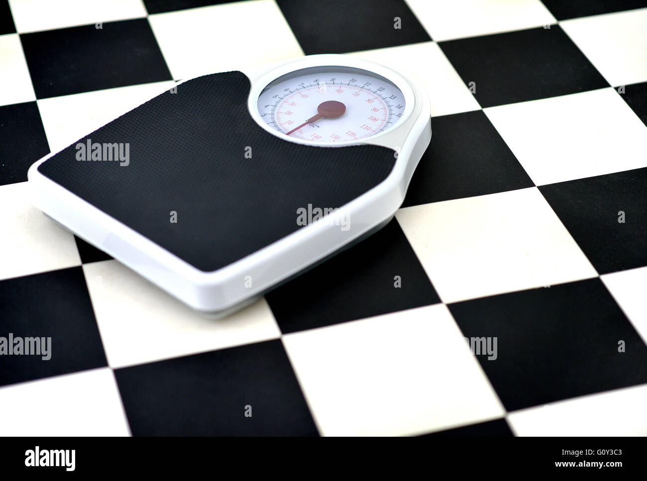 Bathroom scales on checkered floor Stock Photo Alamy