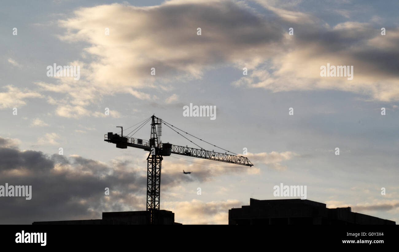 Silhouette of a crane on construction site Stock Photo