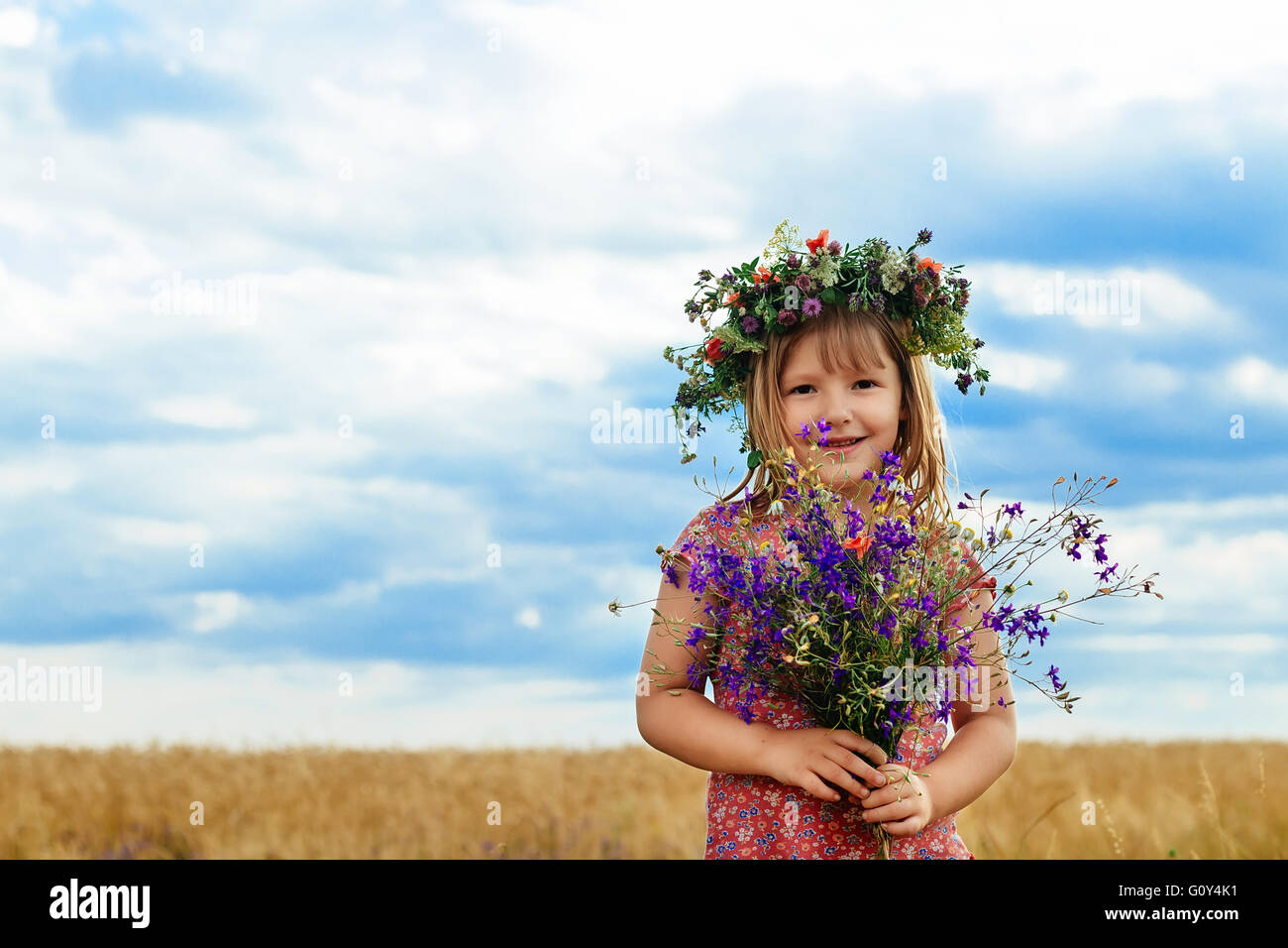 Cute little girl in summer wheat field Stock Photo - Alamy