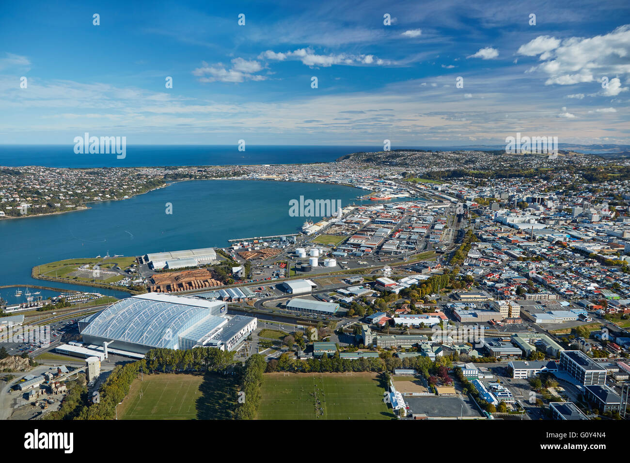 Logan Park, Forsyth Barr Stadium, and Otago Harbour, Dunedin, South Island, New Zealand - aerial Stock Photo
