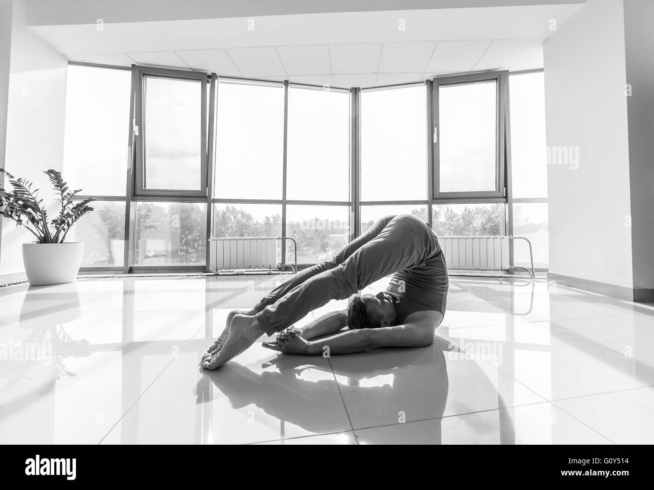 Yoga man training at the gym Stock Photo Alamy