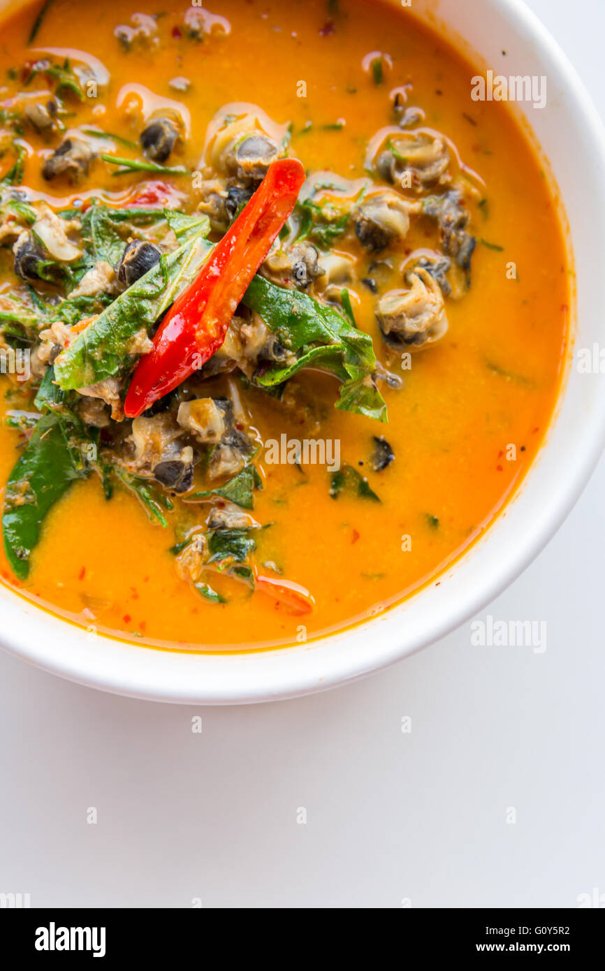 River snail red curry with Acacia pennata on white background Thai Food Stock Photo