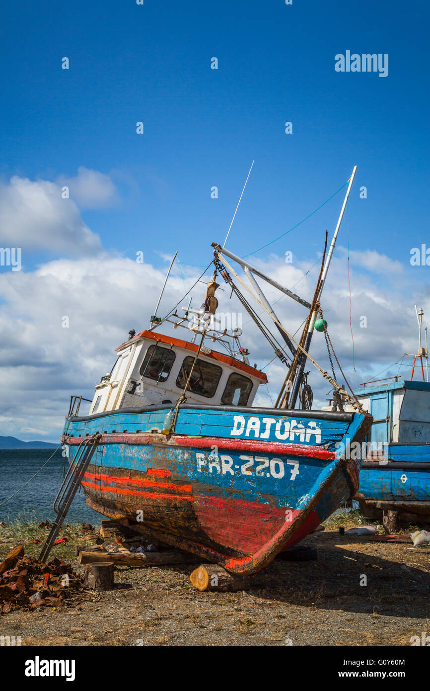 Old fishing boats on the coast on the Strait of Magellan at Punta