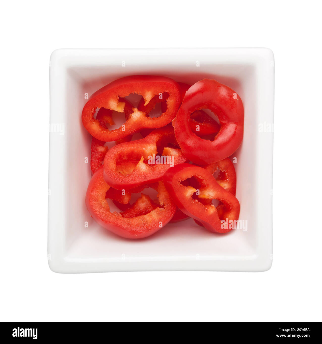 Sliced red bell pepper in a square bowl isolated on white background Stock Photo