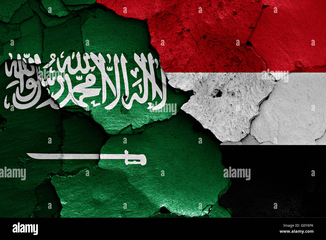 flags of Saudi Arabia and Yemen painted on cracked wall Stock Photo