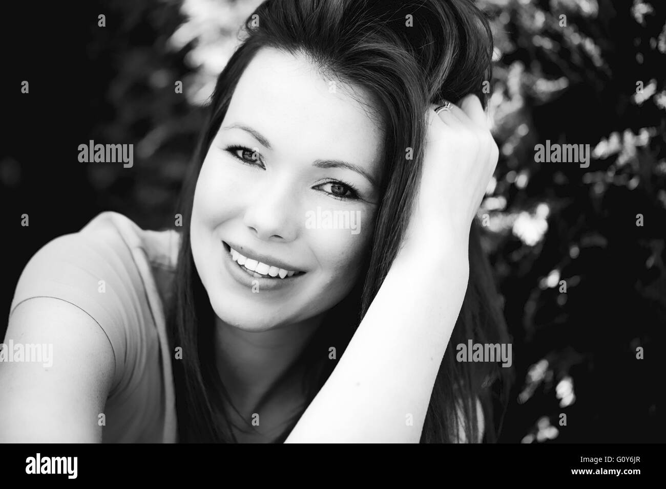 Black And White Portrait Of A Happy Smiling Woman Outside Stock Photo