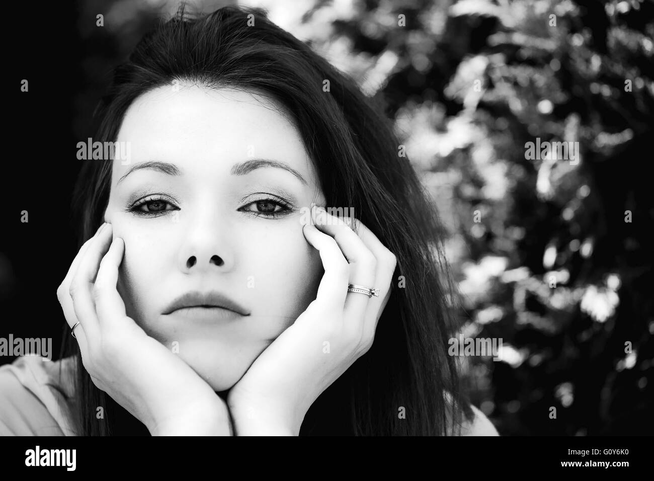 Black And White Portrait Of A Worried Sad Woman Outside Stock Photo