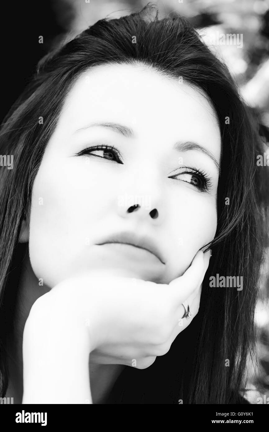 Black And White Portrait Of A Depressed Woman Outside Stock Photo