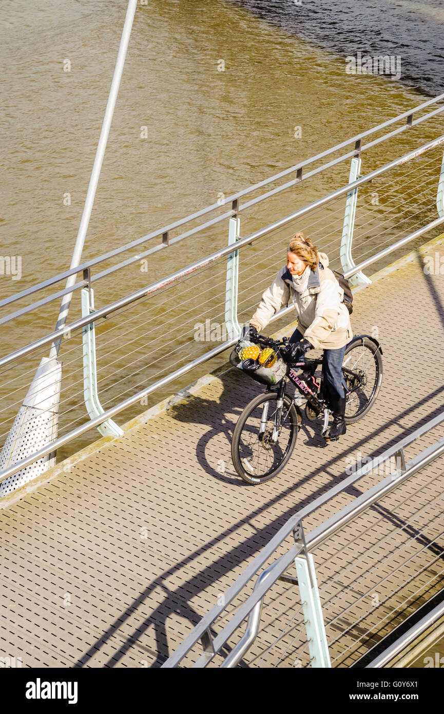 Cyclist on the Millennium Bridge across the River Lune in Lancaster Lancashire Stock Photo
