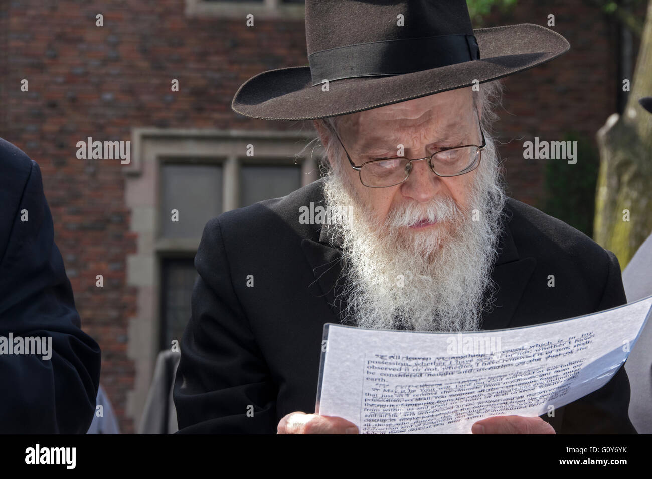 A religious Jewish man reading a prayer after burning his bread
