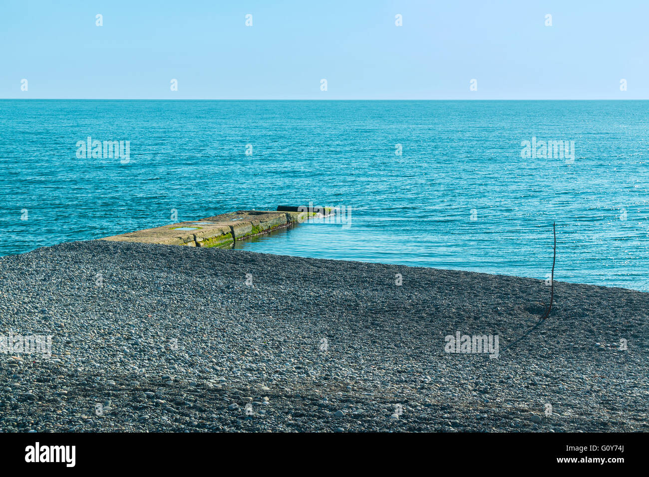 Breakwater and pebble beach with sea views Stock Photo