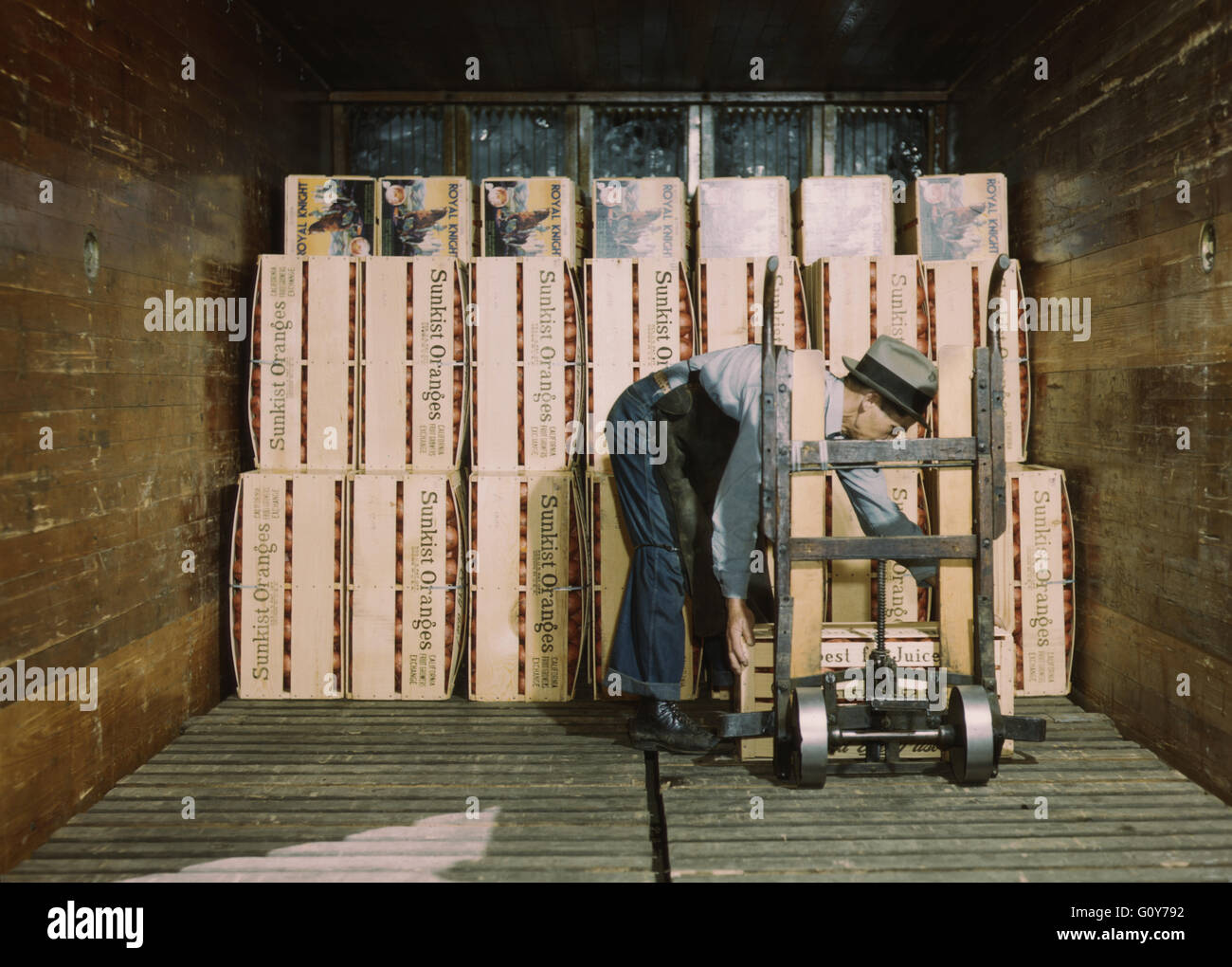 Worker Loading Oranges into Refrigerator Car at a Co-op Orange Packing Plant, Redlands, California, USA, by Jack Delano for Farm Security Administration, circa 1943 Stock Photo