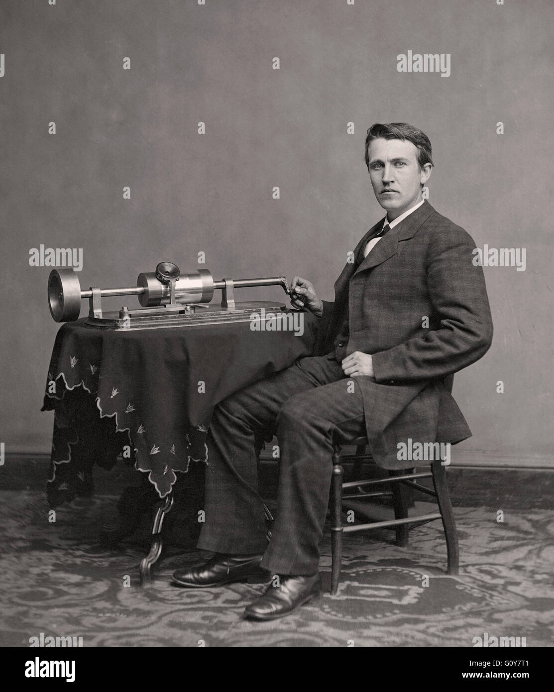 Thomas Alva Edison, 1847 –1931. American inventor and businessman, here seen seated by his 1877 invention, the phonograph.  Photograph by Matthew Brady. Stock Photo
