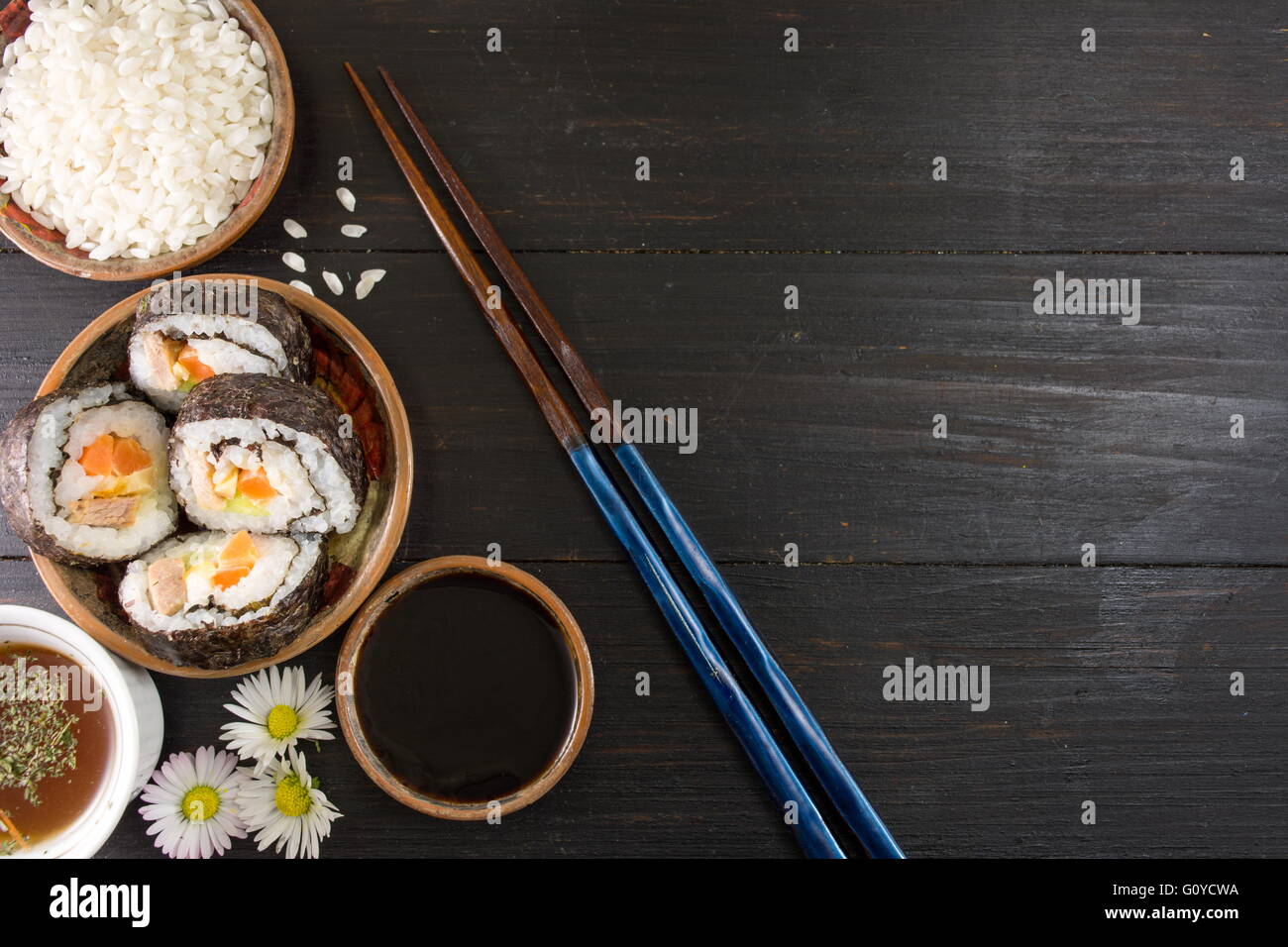 https://c8.alamy.com/comp/G0YCWA/sushi-rolls-and-chopsticks-with-sushi-ingredients-G0YCWA.jpg