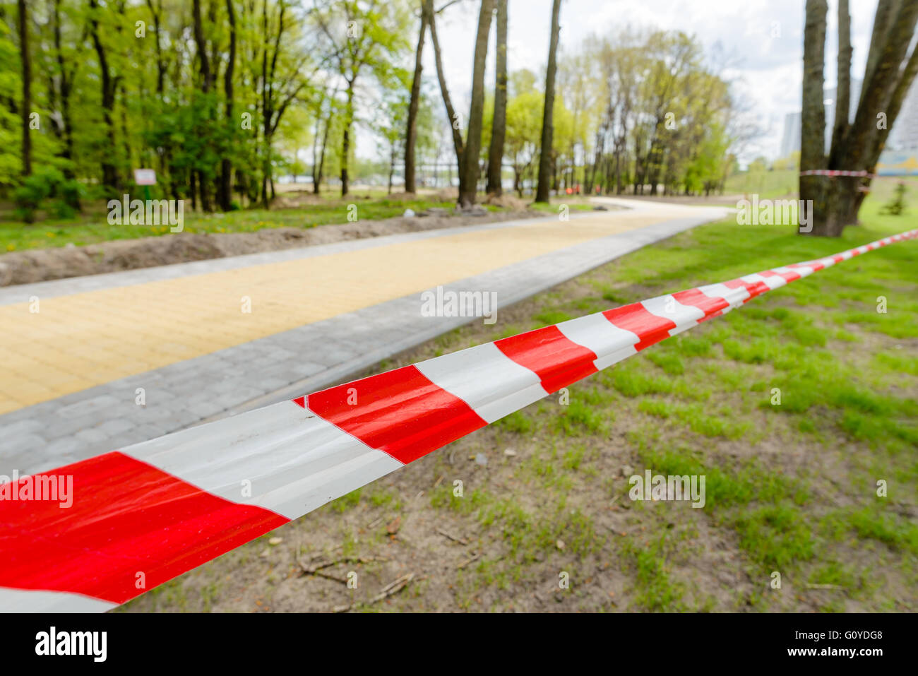 Red and white striped tape defining the border of a dangerous zone of