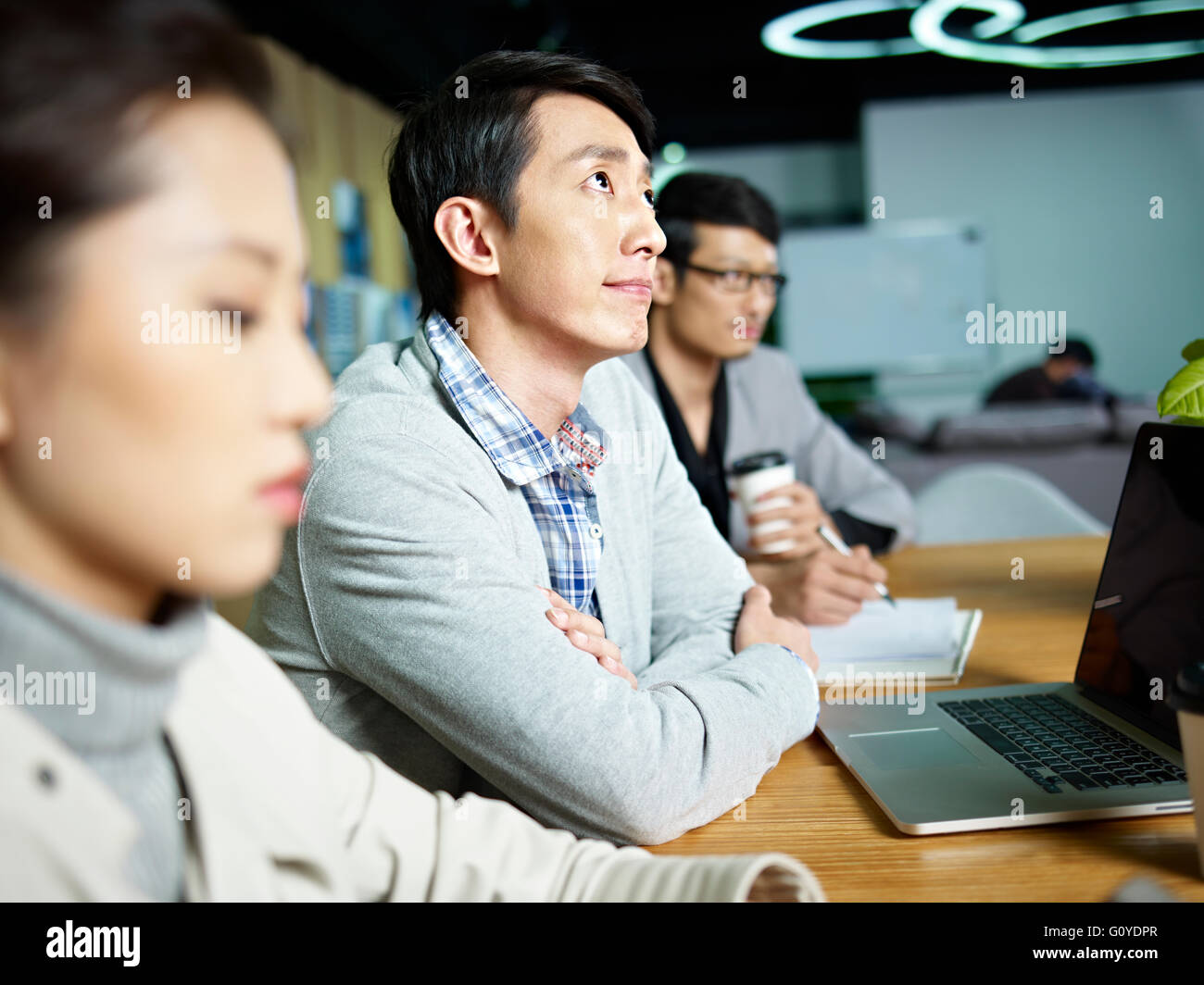 contemplating young asian business person Stock Photo